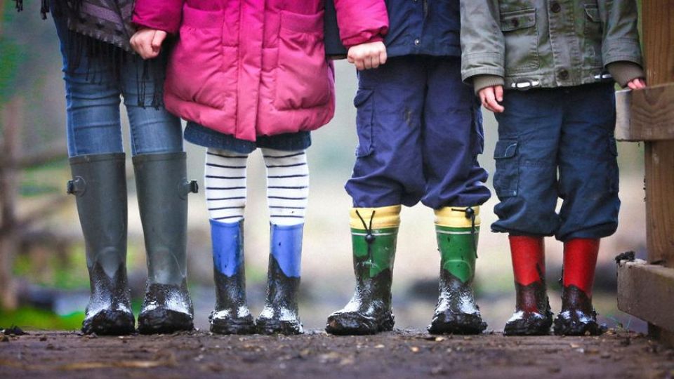 children lined up in boots