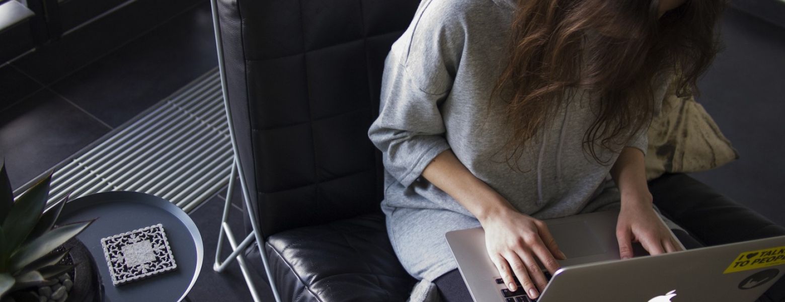 a woman using a laptop in a office chair