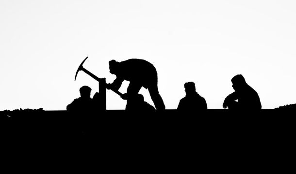 group of people laboring outdoors, silhouette