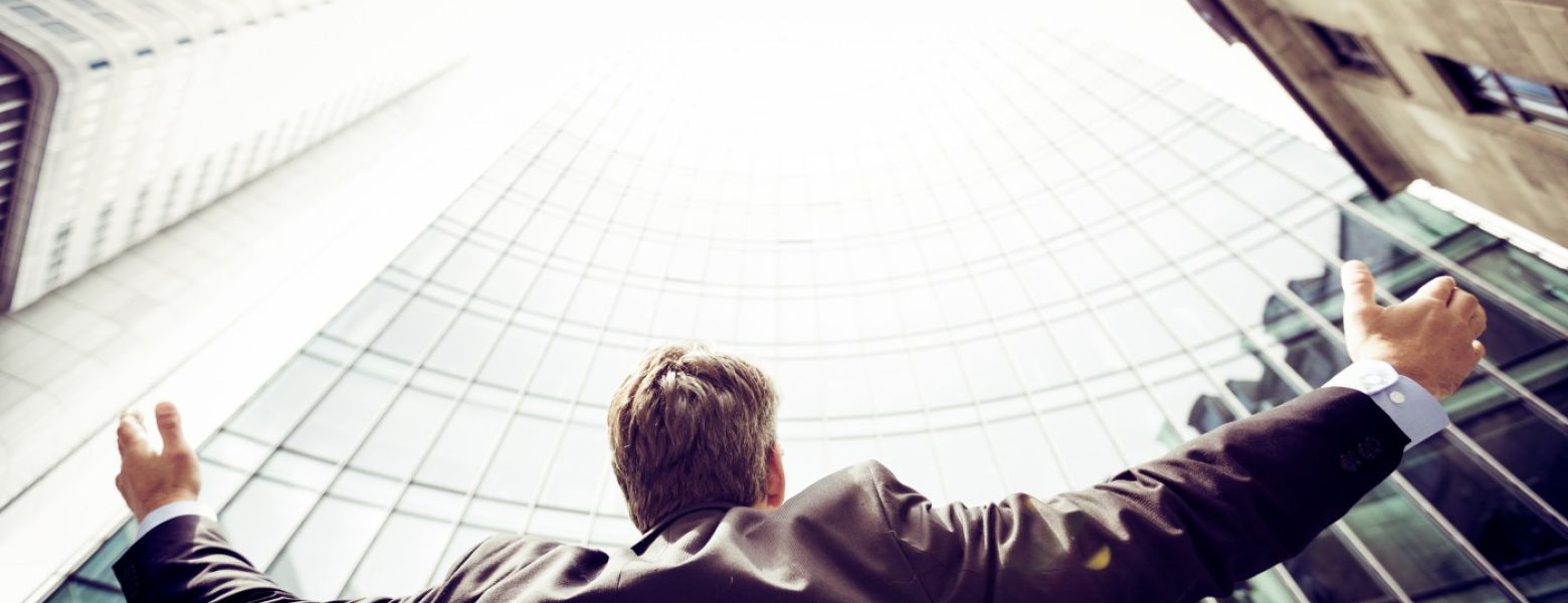 ceo looking up at a building while outdoors