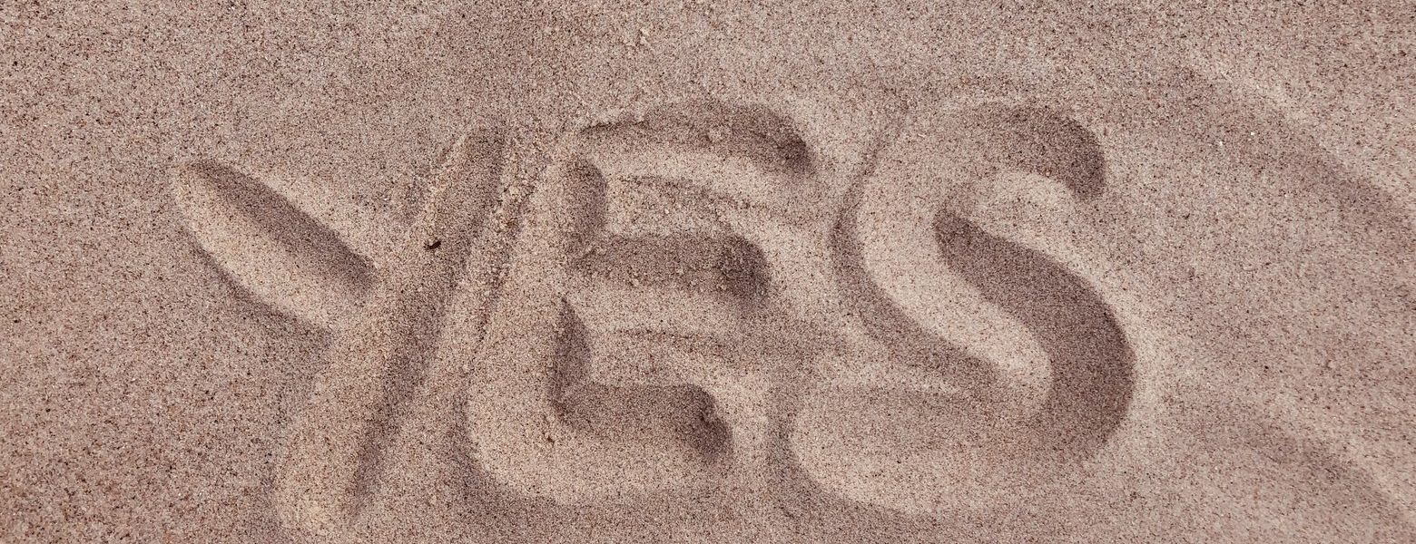 yes written in the sand, outdoors