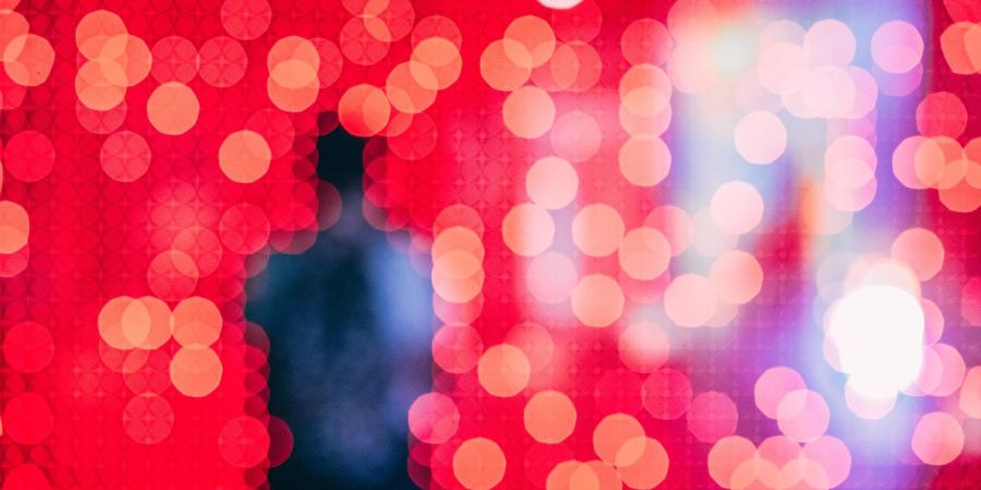 a blurry abstract photo of a person, red background