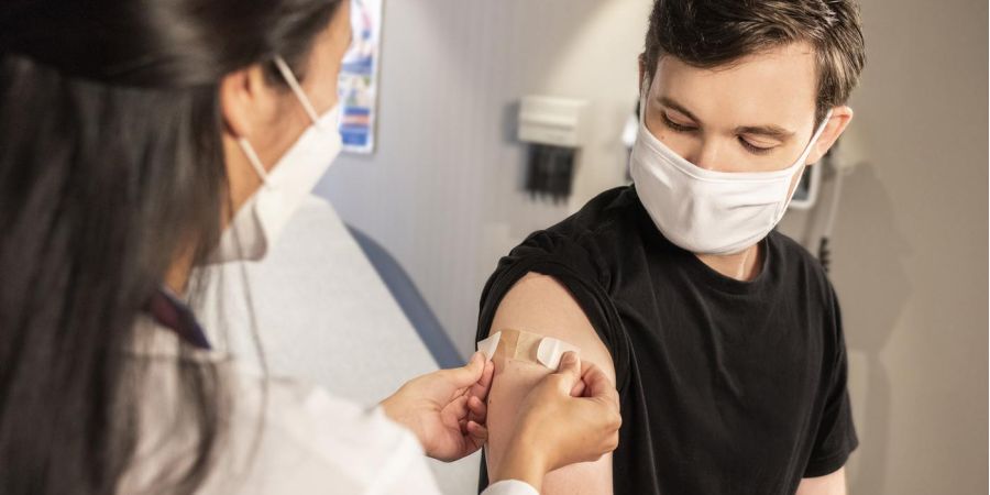 doctor placing a bandaid on a patient, indoor, patient room