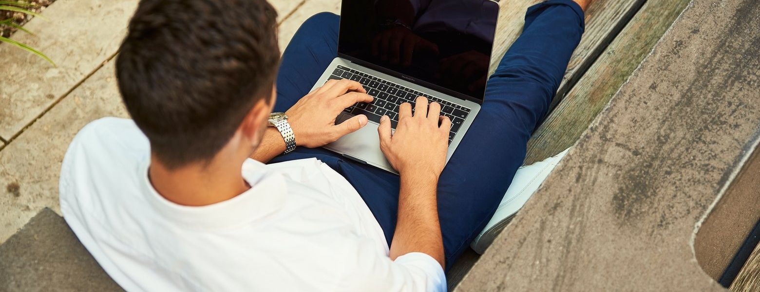 man outdoors using computer