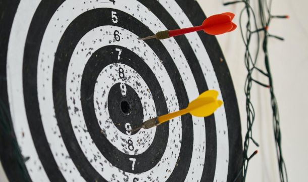 dart target with 2 darts on a wall