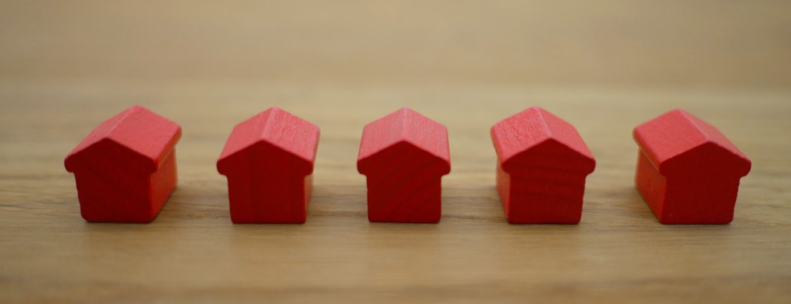 monopoly houses on a wooden table indoors