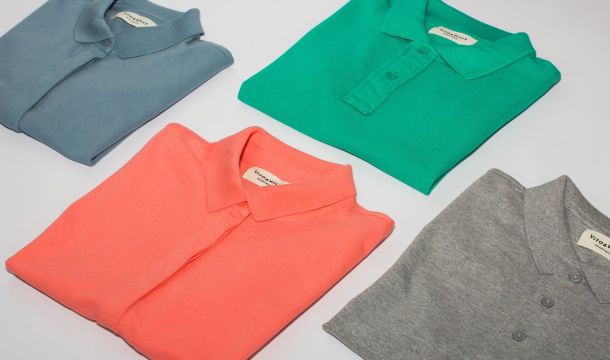 shirts folded and laid out across table, indoors