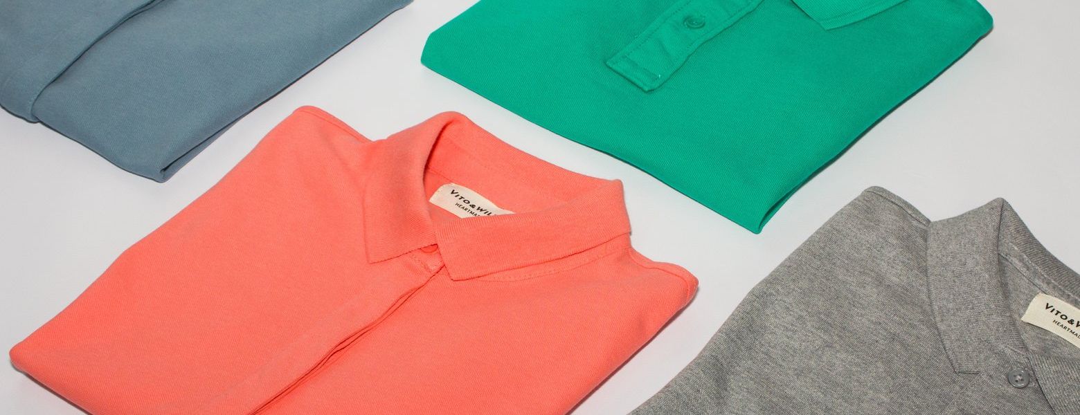 shirts folded and laid out across table, indoors