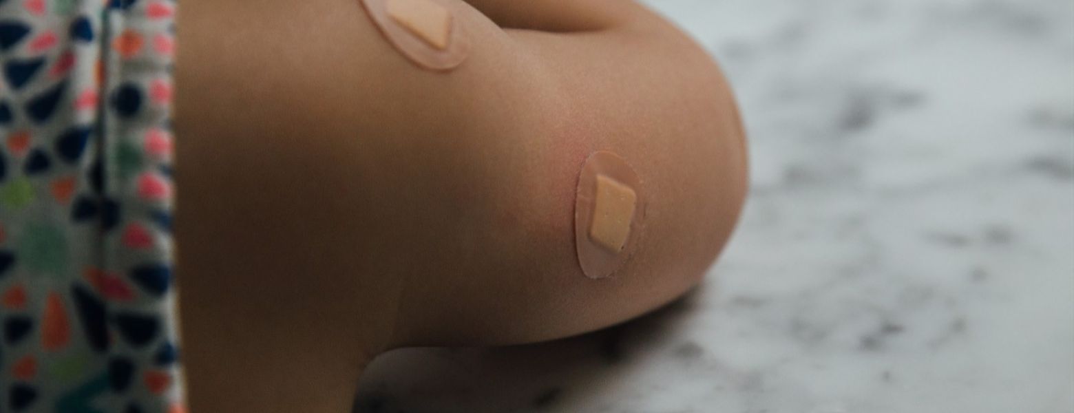 female with bandages where she got shots