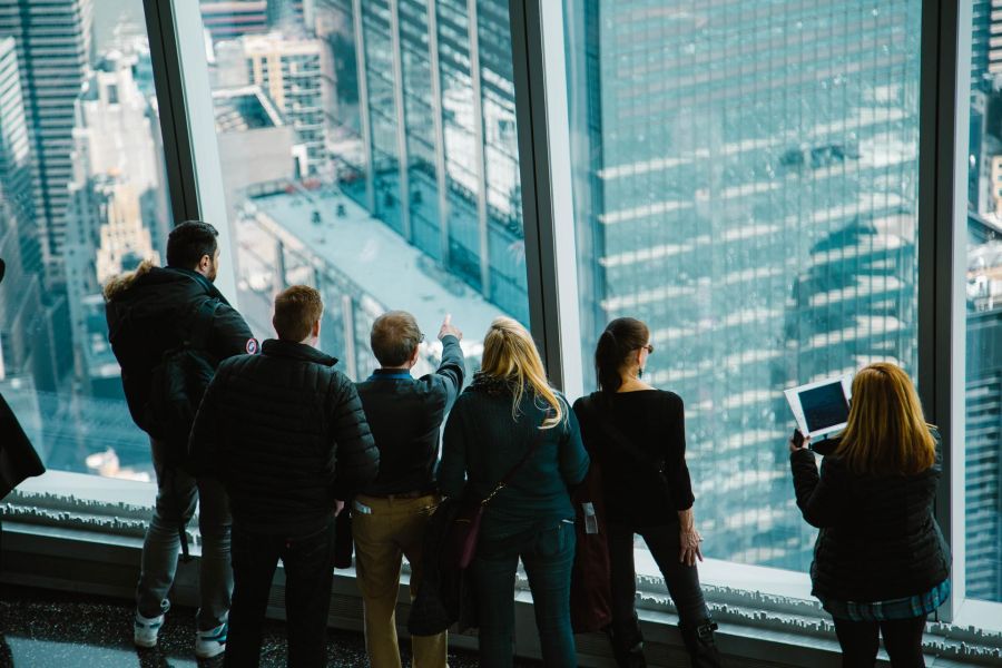 group of people inside a skyscraper looking outside