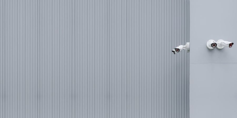 outdoors wall, with white cameras mounted