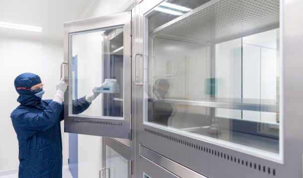 Laboratory technician monitoring environment in lab