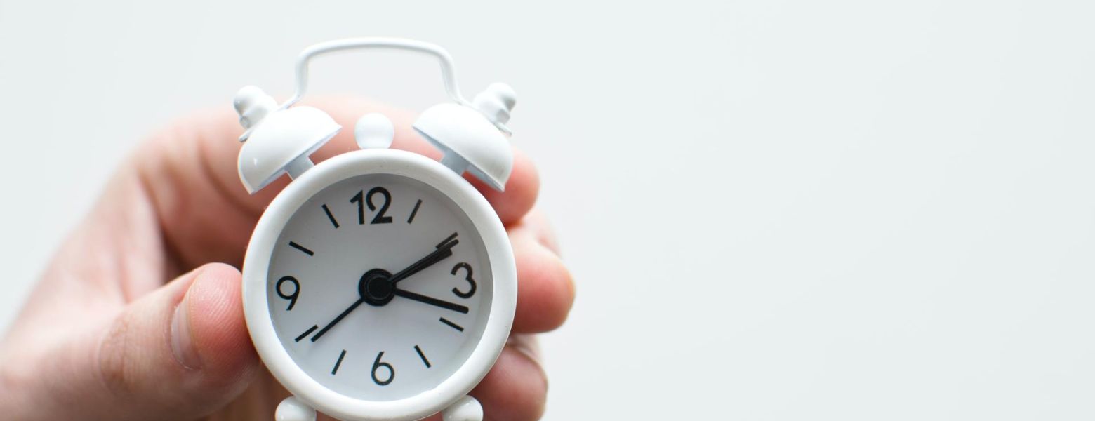 holding a tiny clock