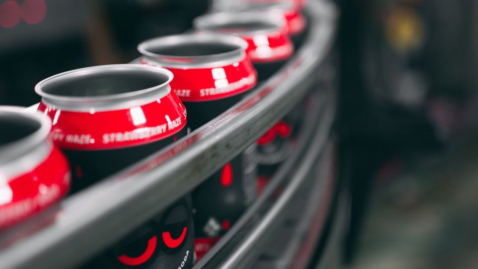 cans of drinks in an assembly line