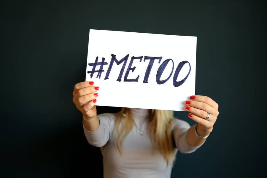 #metoo sign being held by a woman indoors