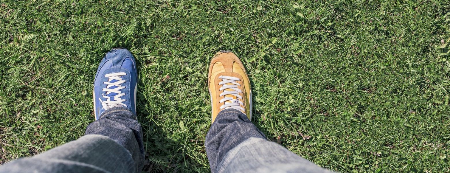 person looking at shoes outdoors two differentt colors