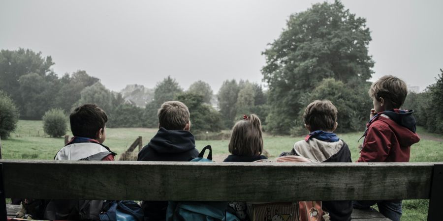 children sitting on a bench