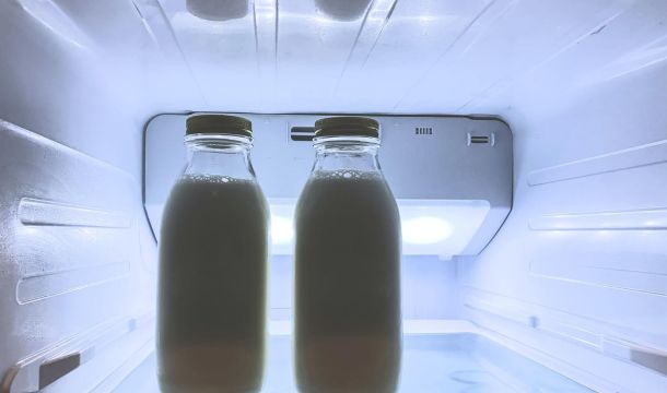 milk in jars inside a refrigerator
