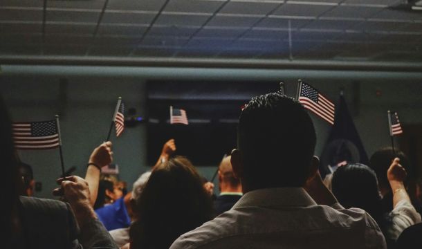 group of people indoors, holding little flags