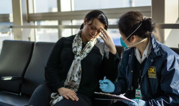 CDC interviewing a sick person inside an airport