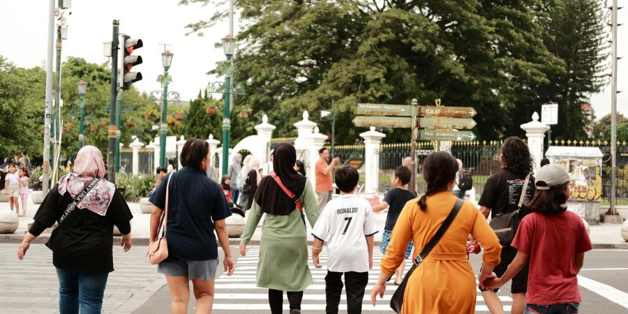 a group of people crossing the street