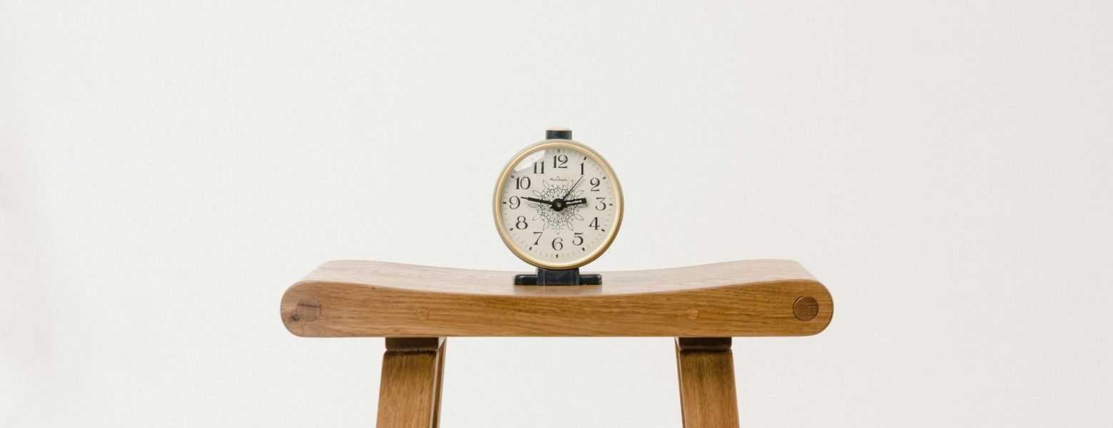 a clock on a little table indoors