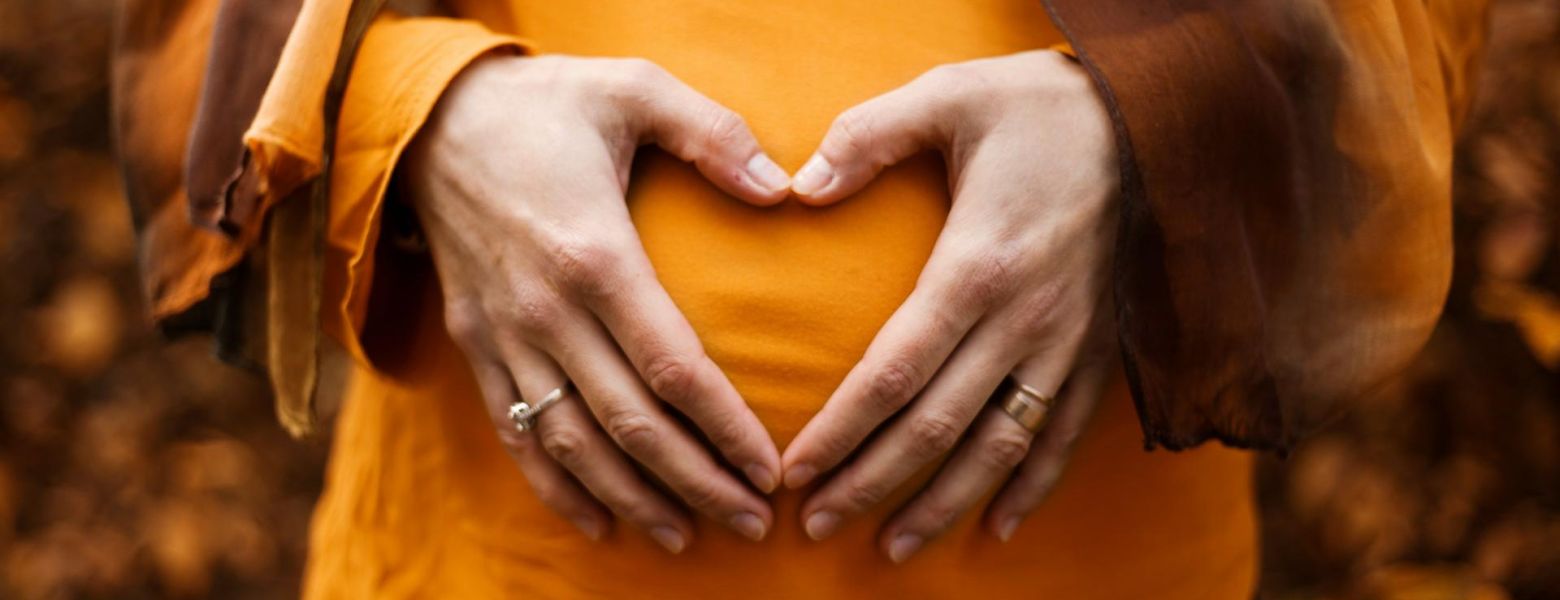 pregnant lady in orange outdoors