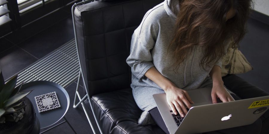 a woman using a laptop in a office chair