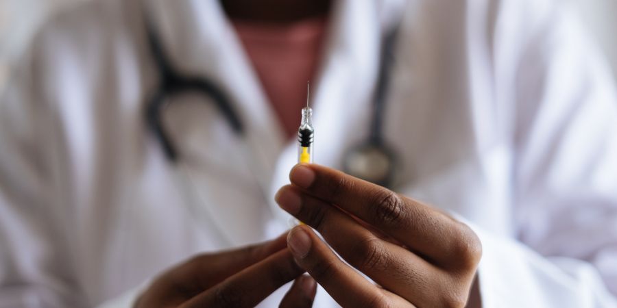 Doctor holding injection needle