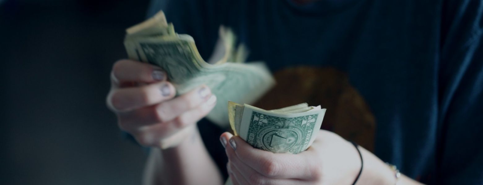 woman counting money dollar bills