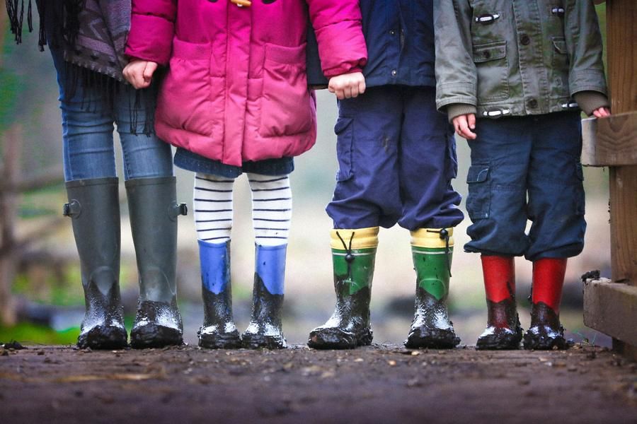 children lined up in boots