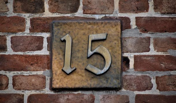 number 15 on a brick wall