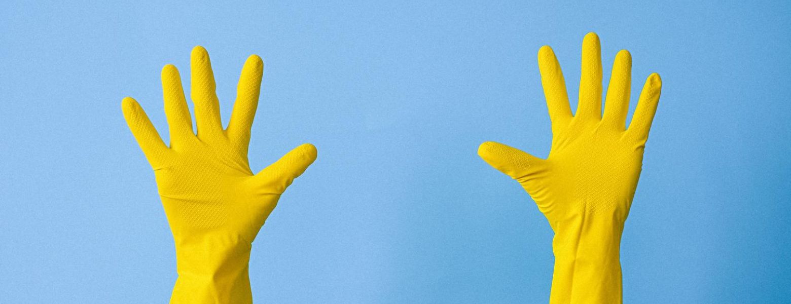yellow rubber gloves on hands reach high