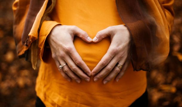 pregnant lady in orange outdoors