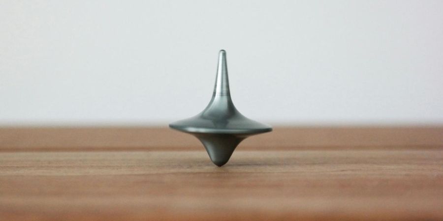 a spinning top on a wooden table