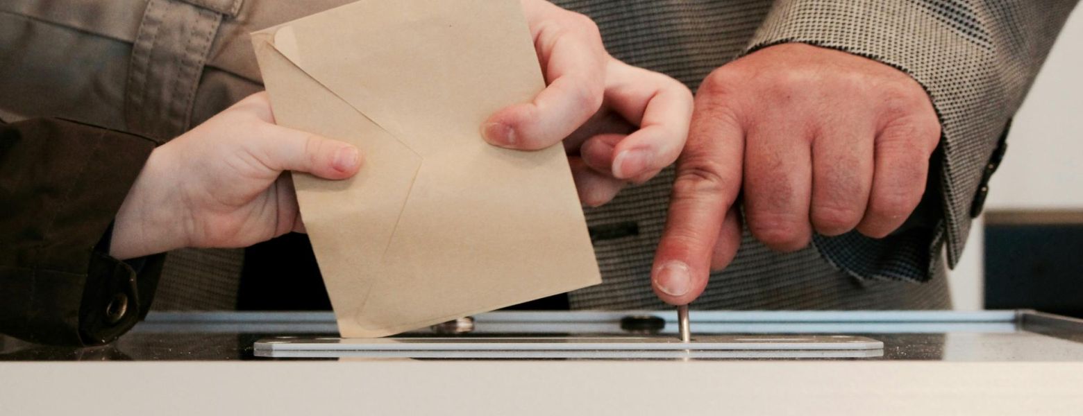 submitting ballot into box