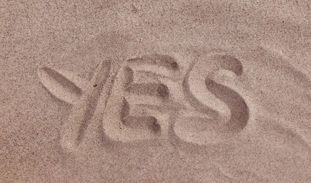 yes written in the sand, outdoors
