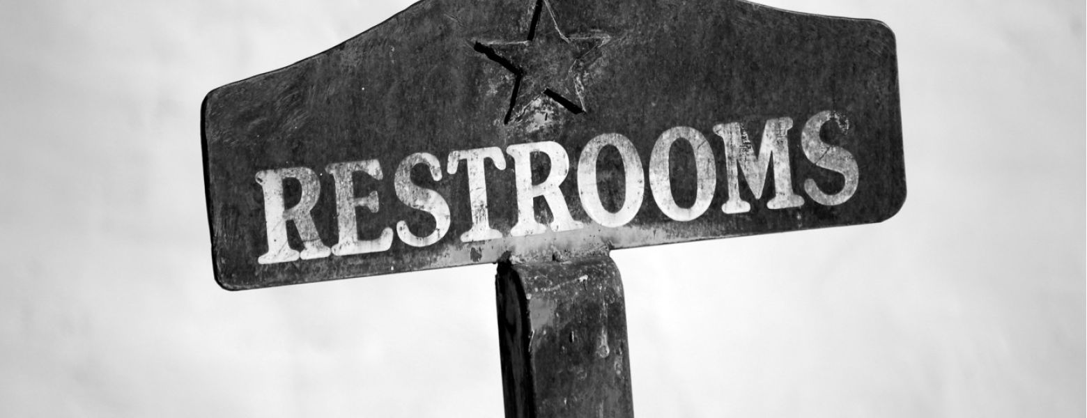 wooden restrooms sign