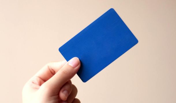 a person holding a blue card, indoors