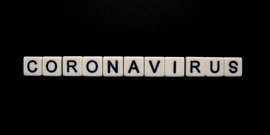 coronavirus letters over a black background