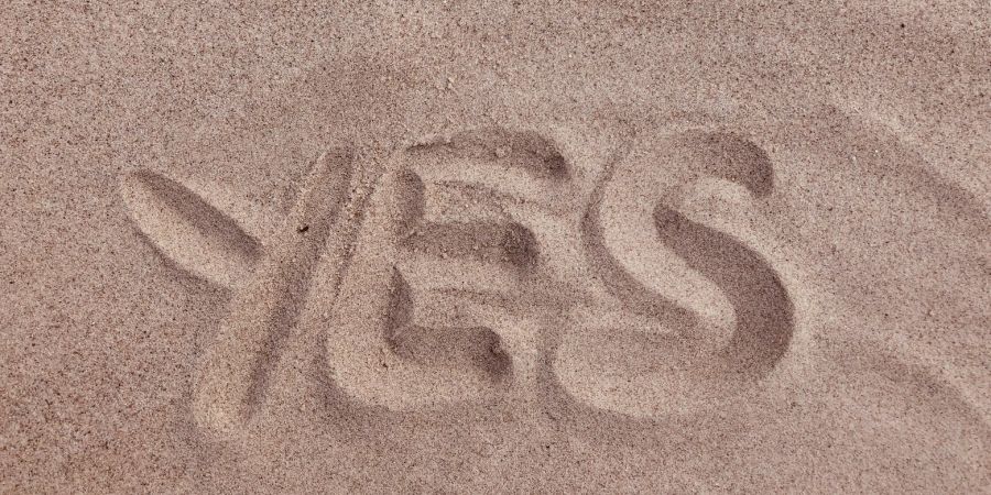 yes written in the sand, outdoors