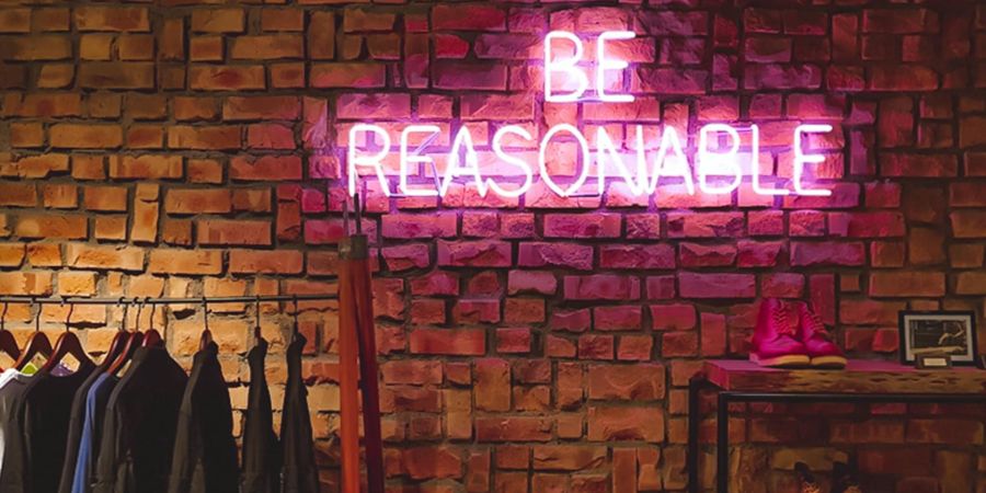 be reasonable, neon sign indoors