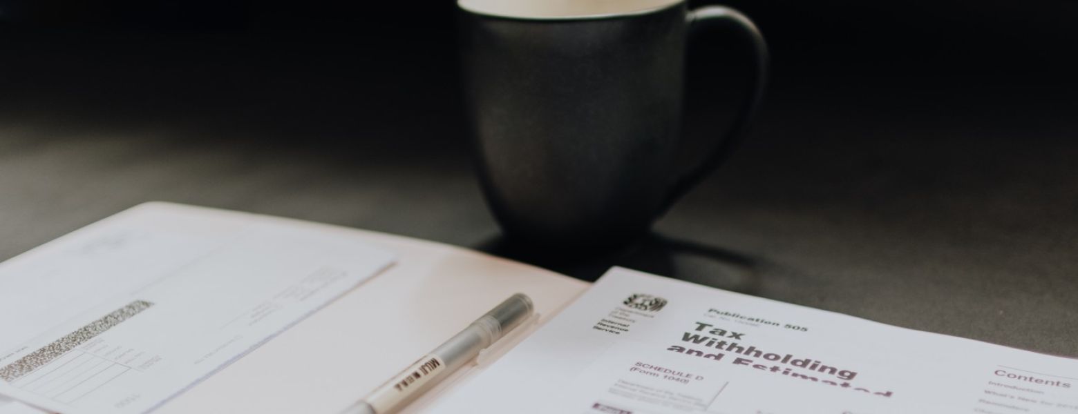 tax papers on a table near a mug