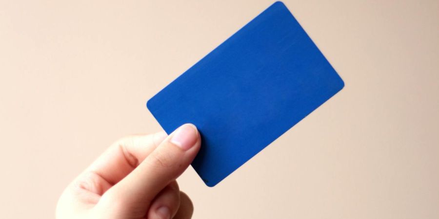 a person holding a blue card, indoors
